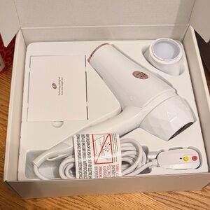 T3 Featherweight 2 blow dryer. White with rose gold accents .